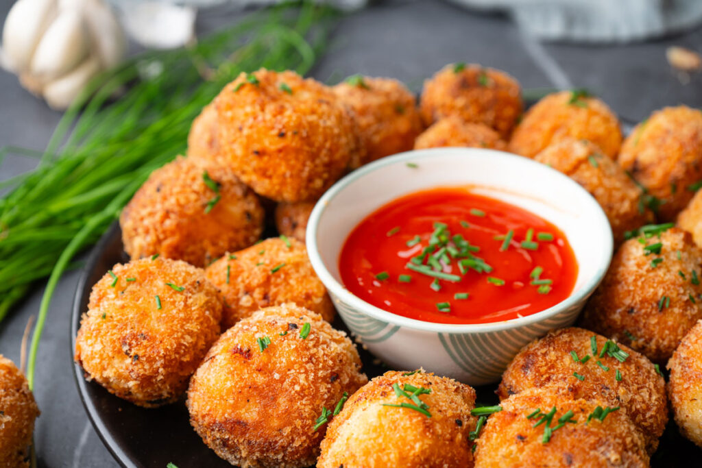 potato bites on plate with marinara