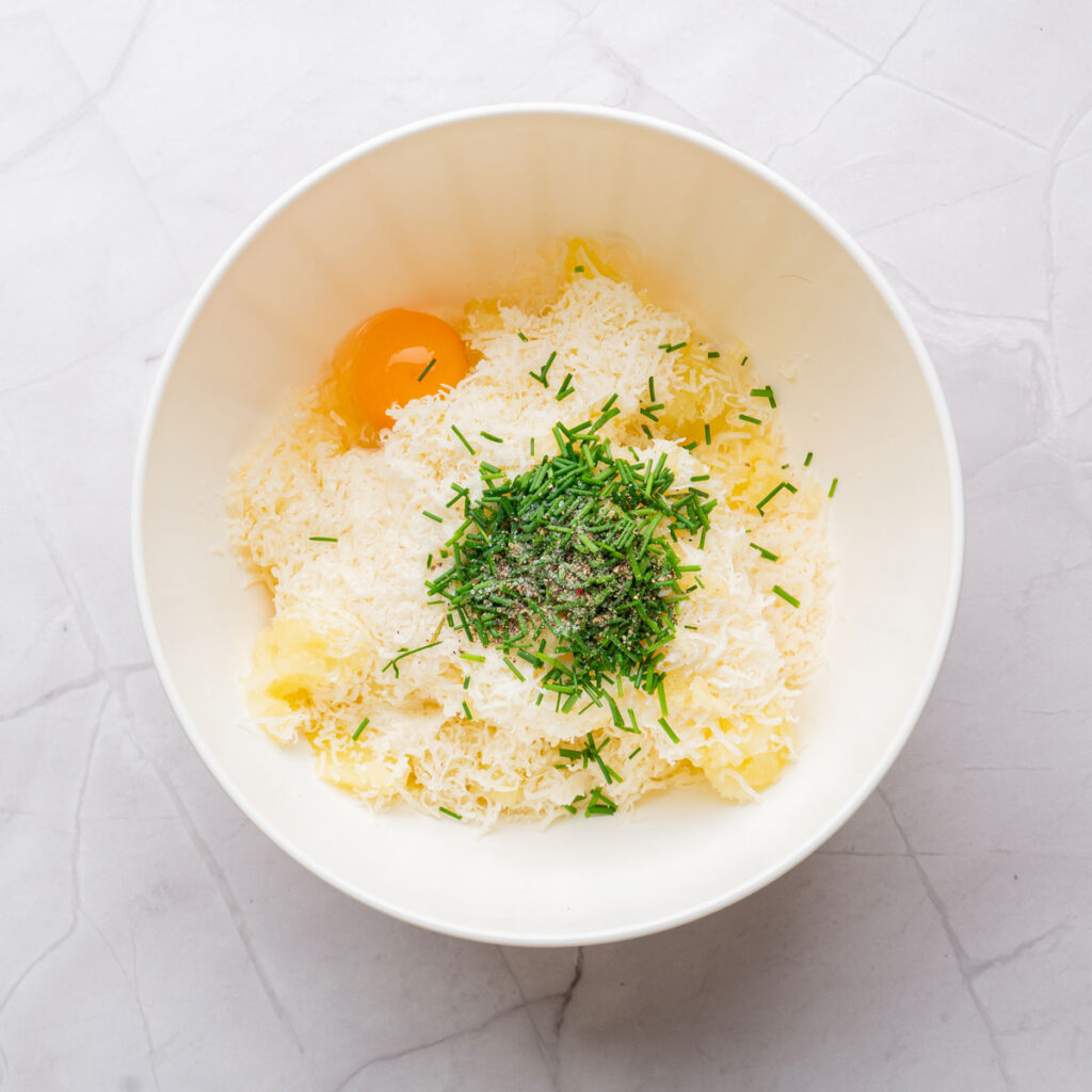 mixing mashed potato balls in white ball