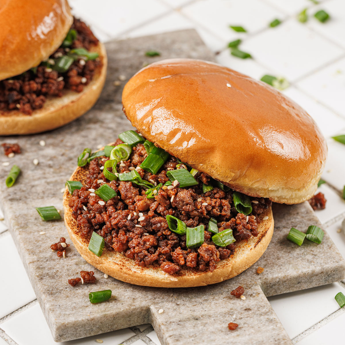 two korean sloppy joes on cutting board