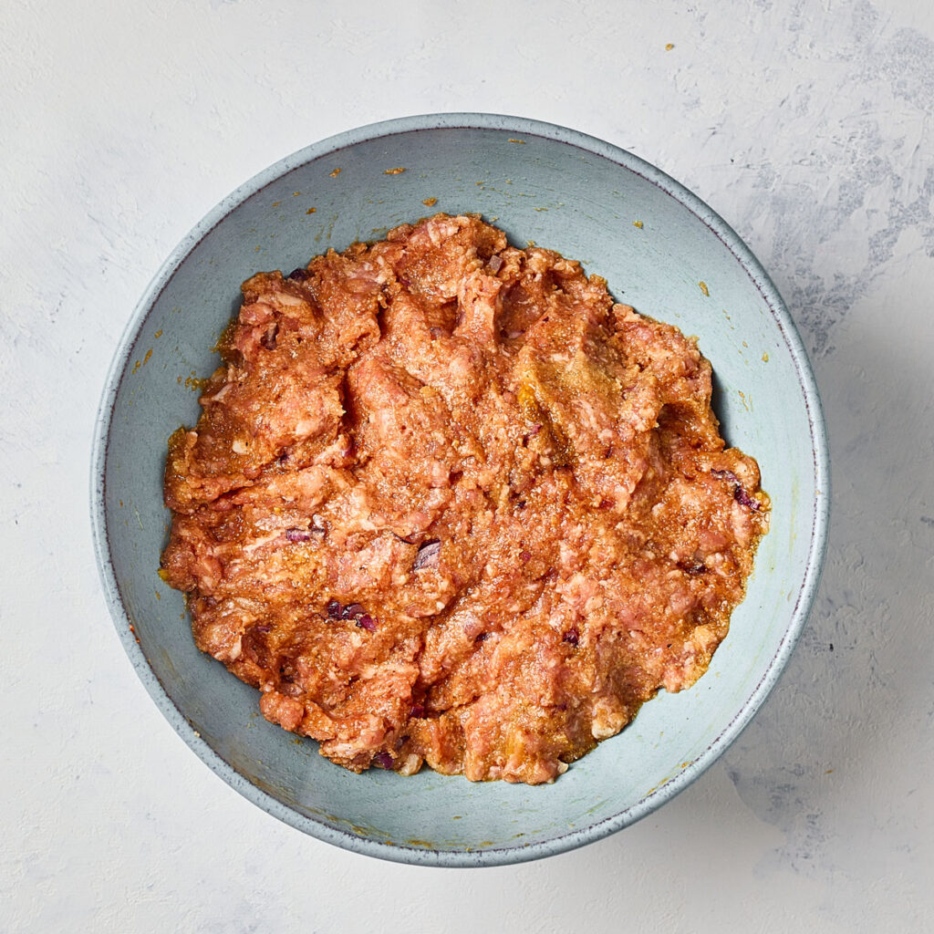 mixing meatball mixture in bowl