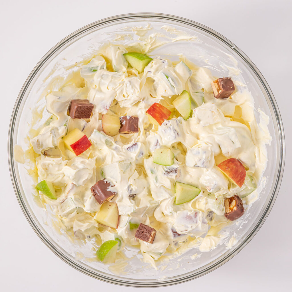 mixing snickers apple salad