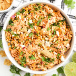 overhead view of street corn chicken salad in white bowl