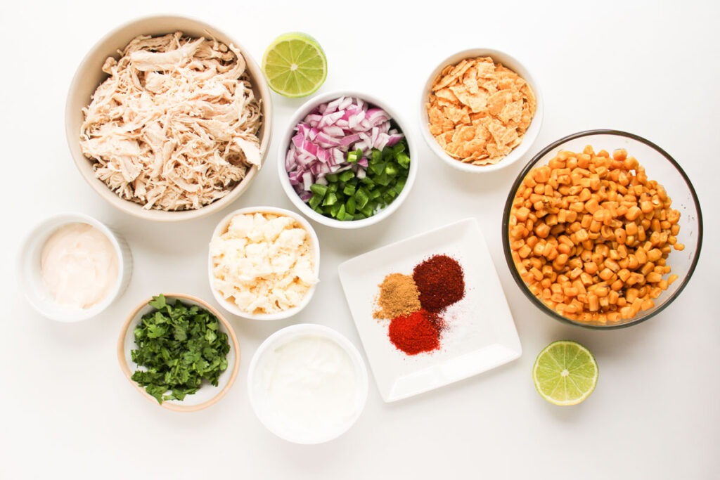 street corn chicken salad ingredients in bowls on countertop
