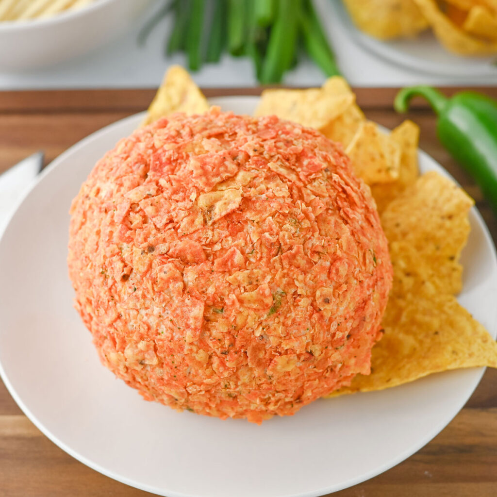 taco cheeseball on white plate with tortilla chips