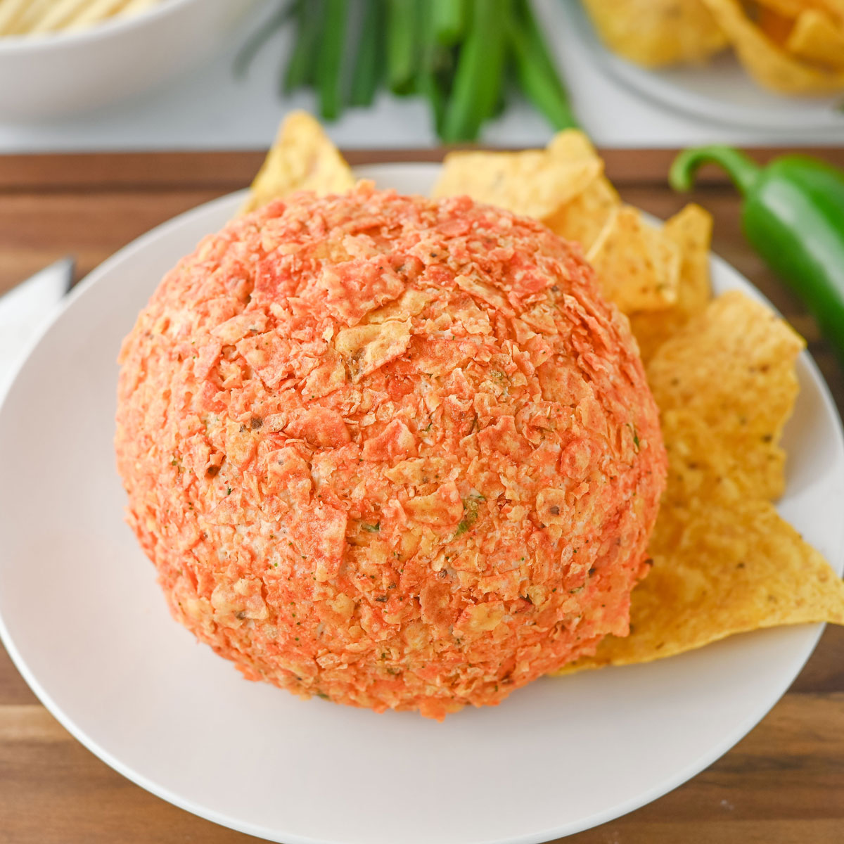 taco cheeseball on white plate with tortilla chips