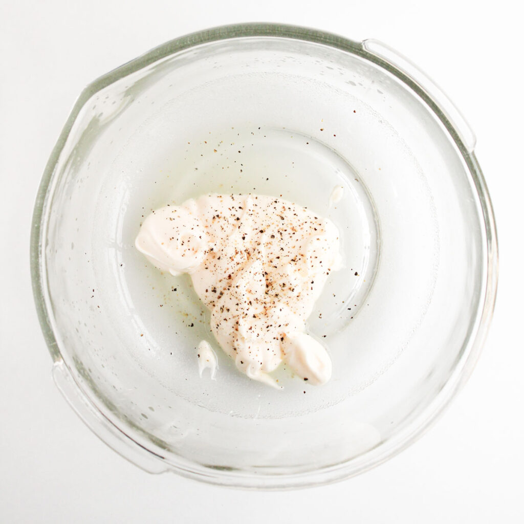 chicken salad pinwheels dressing in glass bowl