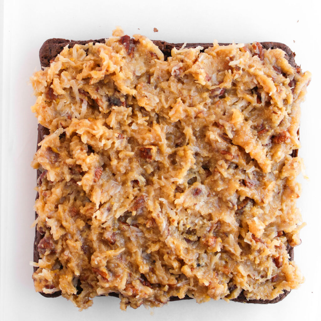 overhead view of german chocolate frosting brownies before slicing