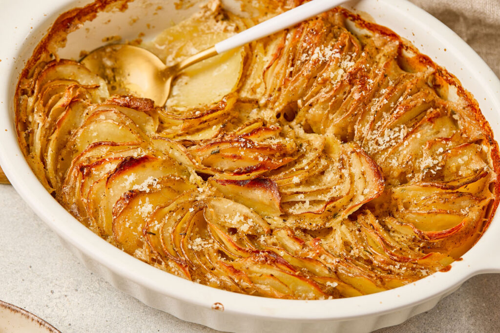 scallop potatoes in white baking dish